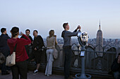 Tourists photograph the fantastic panoramas provided by the Top of the Rock observation deck.  New York City, NY, May 13, 2008