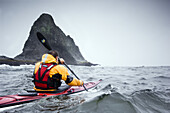 Todd Van Raden braves a 10 foot swell as he sea kayaks around the sea stacks of James Island, Washington coast line, USA, 6 October 2008.