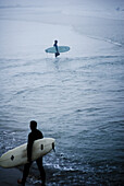 A surfers in the fog at Ocean Beach in San Diego, California.