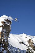 A male skier jumps off a 100 foot cliff known as the diving board in the Grand Targhee Backcountry, Wyoming.