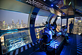 'The Singapore Flyer, a 42 story high observation wheel, was built to give tourists a 360 degree view of Singapore during a 30 minute ''flight'' in the safety and comfort of individual air conditioned cabins which each weight 16 tons and can hold up to 28