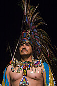 A male performer wears an elaborate costume as an Aztec king during the performance of Bani Stui Gulal in Dance Square, next to the Basilica de la Soledad, in Oaxaca City, Oaxaca state, Mexico on July 19, 2008. The show tells the story of the Guelaguetza 