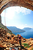 Stacey Michele belays Alex Honnold as he climbs the steep limestone cave on the Greek Islands