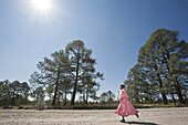 Two tarahumara girls wearing traditional clothes running a 21K race on a dirt road during the  Ultramaraton de los Canones in Chihuahua,  Mexico.