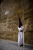 A penitent holds a candle during an Easter Holy Week procession in Carmona village, Seville province, Andalusia, Spain, April 19, 2011.