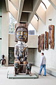 VANCOUVER, BRITISH COLUMBIA, CANADA. A man walks through a museum filled with Native American art.