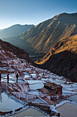 OLLANTAYTAMBO, SACRED VALLEY, PERU. Tourists stand at the salt pools near Maras, a site used by Incan civilizations centuries ago and still in use today.
