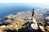 Susann Scheller standing on top of Lion's Head looking down at the city of Cape Town. South Africa.