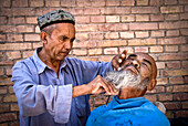 Street barber, Kashgar, Xinjiang Province, China.