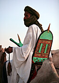 Touareg man watching a crowd of people.