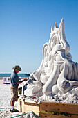 A professional sand sculptor works on the beach during a competition in Siesta Key, FL.
