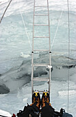 Don't look down: Crossing a ladder-bridge in the Khumbu Icefall, Everest, Nepal.