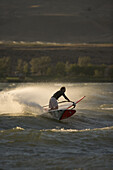 Jason Russ lays a big spray up into the last bits of light on the Columbia River