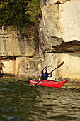 Lydia McDonald explores via sea kayak the large sandstone cliffs that line Summersville Lake near Fayetteville, WV