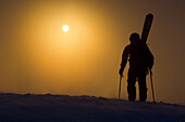Lorenzo Worster hiking with skis up Mount Glory at sunrise on Teton Pass in Jackson, Wyoming.  Jimmy Chin / Aurora Photos 