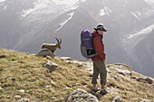 A woman and an ibex near Mont Blanc in the French Alps.