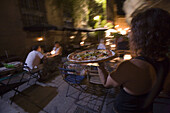'Karine Gauthier delivers an oven baked pizza to patrons enjoying the outdoor patio of ''La Pizza'' restaurant on the streets of downtown Aix-en-Provence, France. releasecode: ab0175,'