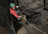 Rob Eavis passes a re-belay underground in a cave in the White Mountains on the island of Crete.