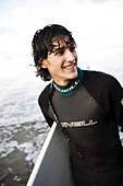 Surfer smiles for the camera in San Diego, CA. releasecode: 20061128