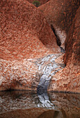 ULURU, AUSTRALIA - JULY 20: The Mutitjulu Waterhole at Uluru - Kata Tjuta National Park in the Northern Territory of Australia, July 20, 2006. The watering hole is part of Uluru, also known as Ayers Rock. Uluru juts 1141 feet above ground, though two-thir