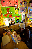 One man works on his computer at a coffee shop in Bar Harbor, Maine, the gateway to Acadia National Park. releasecode: LS_004_jb