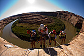 left to right, Millie team members Zoe King and Matt Acheson and Radioactive Beagles team members Robert Beauchamp and Tom Sullivan begin a rappel during the ropes leg of day three of the 2006 Primal Quest adventure race in Moab, Utah.  It was the largest