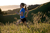 MILL VALLEY, CA - MAY 8, 2007: As sunset nears, a runner follows a tiny, single-track trail along the western slopes of Northern California's Mount Tamalpais. Photo by Eric Rorer/Aurora, releasecode: rorer_0013