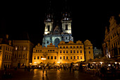 Night view of Old Town Square with tourist cafe and the front facade of the Church of Our Lady Before Tyn, in Prague, Czech Republic.