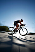Female triathlete Megan Banks races bicycle during first annual 2007 Portland Triathlon in Portland, Oregon.  The race is carbon neutral.