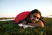 Man inside sleeping bag on the coast of Maine, New England. releasecode: rattan