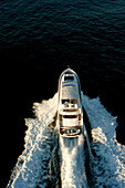The motor yacht Alani a Sunseeker 82 in the bay of Sydney during the sunrise on this way to the ocean.