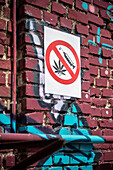 Prohibition sign for drug usage on a wall sprayed with Graffiti in Berlin Friedrichshain, Berlin, Germany
