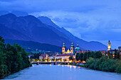 View over Inn river to Cathedral of St. James and City Tower in the evening, Karwendel with mount Bettelwurf in background, Innsbruck, Tyrol, Austria