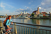 Cyclist looking over Danube river to Passau, Lower Bavaria, Germany