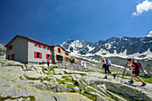 Two persons hiking towards hut Rifugio Ponti, Rifugio Ponti, Sentiero Roma, Bergell range, Lombardy, Italy