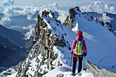 Woman descending from summit of Gran Paradiso, Gran Paradiso, Gran Paradiso Nationalpark, Graian Alps range, valley of Aosta, Aosta, Italy