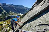 Woman climbing on granite slab, Azalee Beach, Grimsel pass, Bernese Oberland, Switzerland