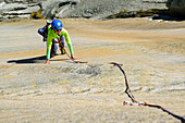 Frau klettert an Granitplatten, Sektor Crow, Grimselpass, Berner Oberland, Schweiz