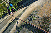 Woman climbing on granite slab, Sector Crow, Grimsel pass, Bernese Oberland, Switzerland