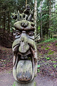 Wood carvings from traditional folklore at The Hill of Witches on the Dano River at the northern tip of the Curonian Spit, Klaipedia, Lithuania, Europe
