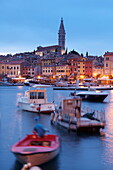 Ships and boats in the harbour and the old town with cathedral of St. Euphemia at dusk, Rovinj, Istria, Croatia, Europe