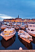 Ships and boats in the harbour and the old town with cathedral of St. Euphemia at dusk, Rovinj, Istria, Croatia, Europe