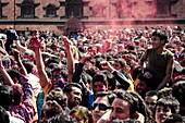A crowd gathers in Basantapur Durbar Square to celebrate the Holi festival, Kathmandu, Nepal, Asia