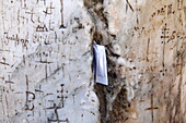 In the cracks of the stone pillars some believers insert prayer notes, Holy Sepulchre Church, Jerusalem, Israel, Middle East