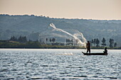 Local fisherman in a dug-out canoe in Jinja, Uganda, East Africa, Africa