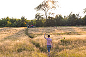 Mother waving to her son (4 years), Marielyst, Falster, Denmark