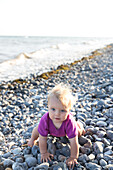Girl (1 year) at pepple beach, Klintholm, Mon island, Denmark