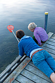 Mother and son (4 years) on a jetty, Gedser, Falster, Denmark