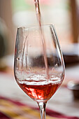Pouring glass of rose wine