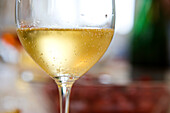 Droplets of condensation on glass of chilled white wine